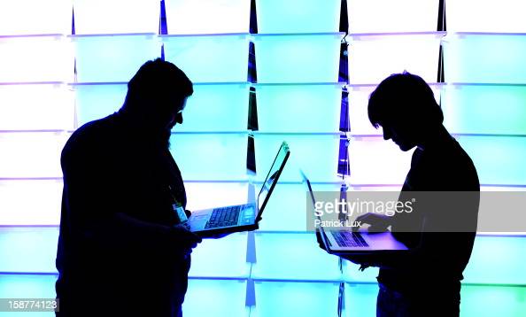 HAMBURG, GERMANY - DECEMBER 28:  Participant hold their laptops in front of an illuminated wall at the annual Chaos Computer Club (CCC) computer hackers' congress, called 29C3, on December 28, 2012 in Hamburg, Germany. The 29th Chaos Communication Congress (29C3) attracts hundreds of participants worldwide annually to engage in workshops and lectures discussing the role of technology in society and its future. (Photo by Patrick Lux/Getty Images)